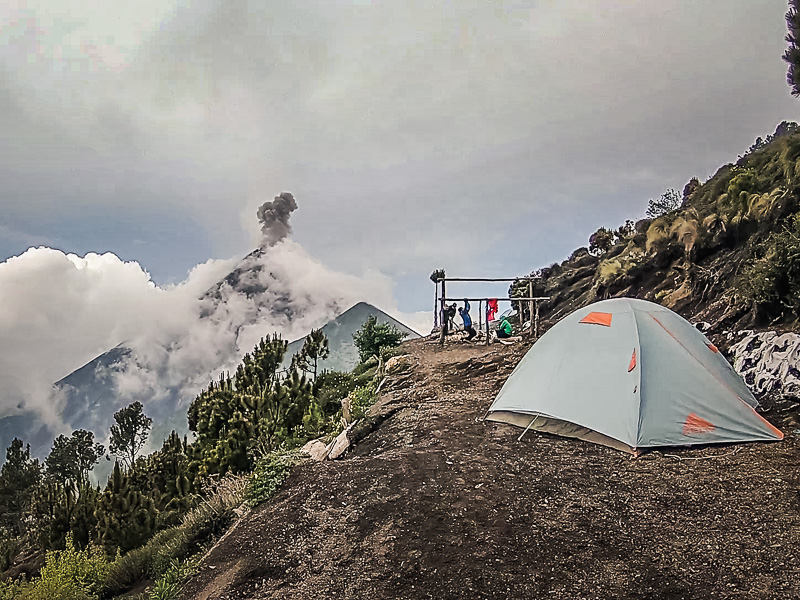 Setting up tents whilst Volcan Fuego erupts in the background